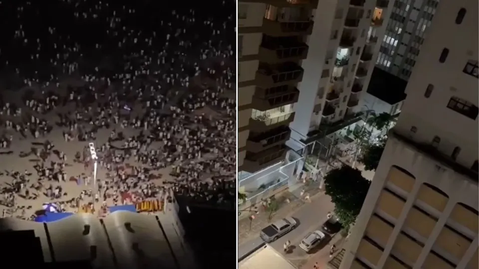 Após a queima de fogos, um grupo intimida frequentadores na praia das Pitangueiras, em Guarujá, São Paulo.